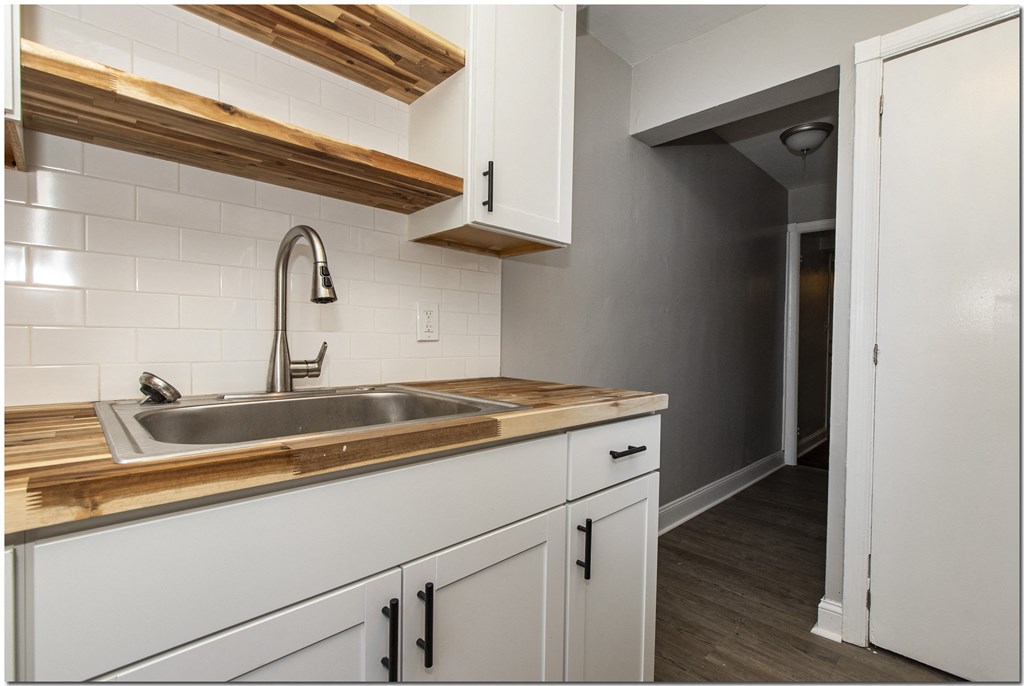 a kitchen with white cabinets and a sink