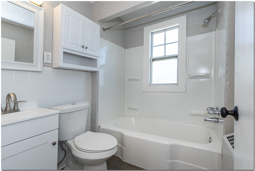 a bathroom with a toilet sink and bathtub