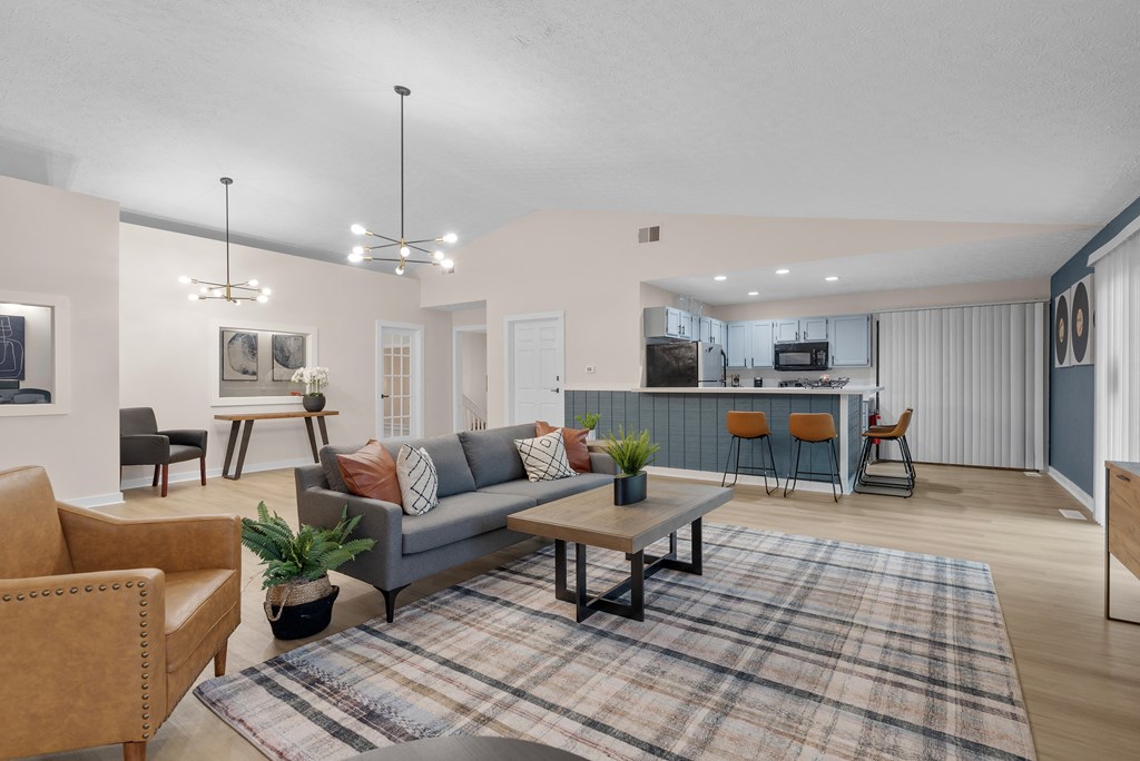A living room with a grey couch and a wooden coffee table.