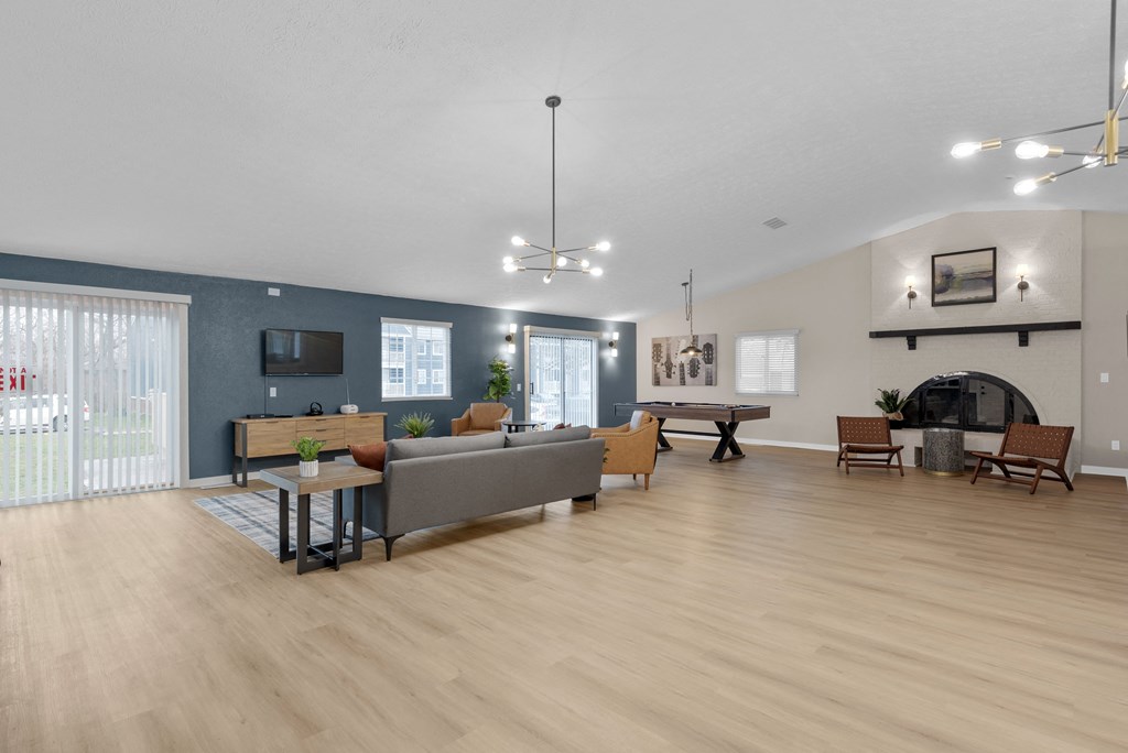 A living room with a grey couch, a wooden table, and a television.