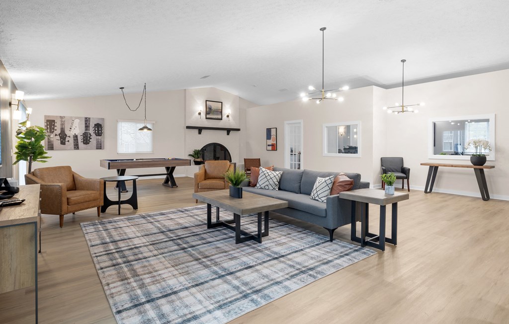 A living room with a grey couch, a coffee table, and a rug.