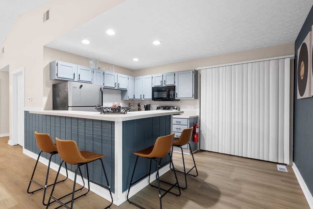 A kitchen with a white ceiling and a white refrigerator.