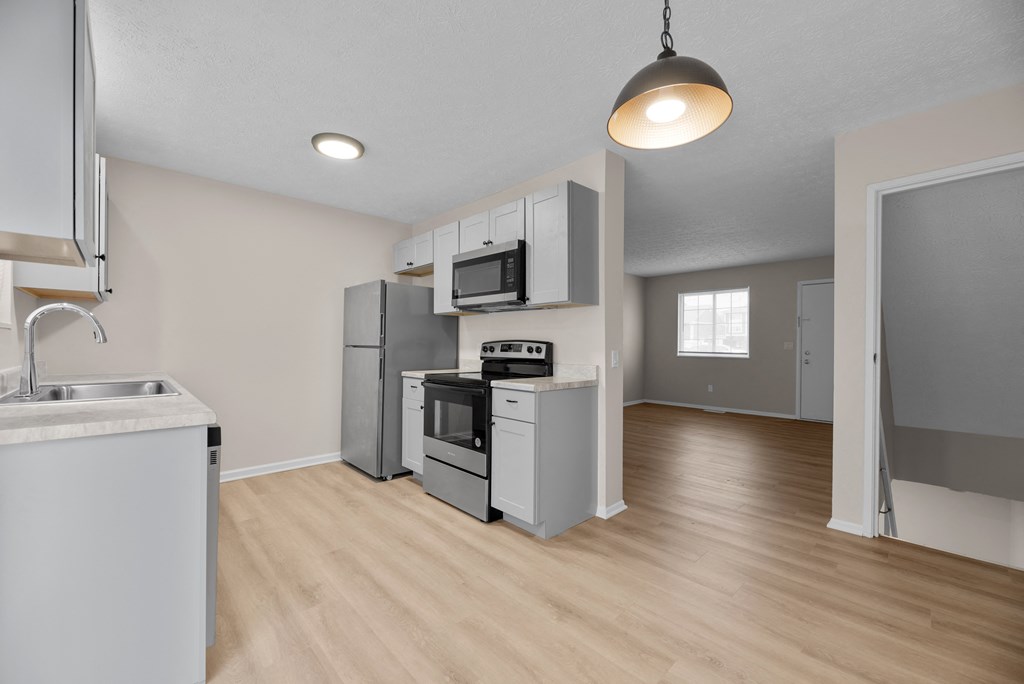 A kitchen with a stove, oven, and sink.