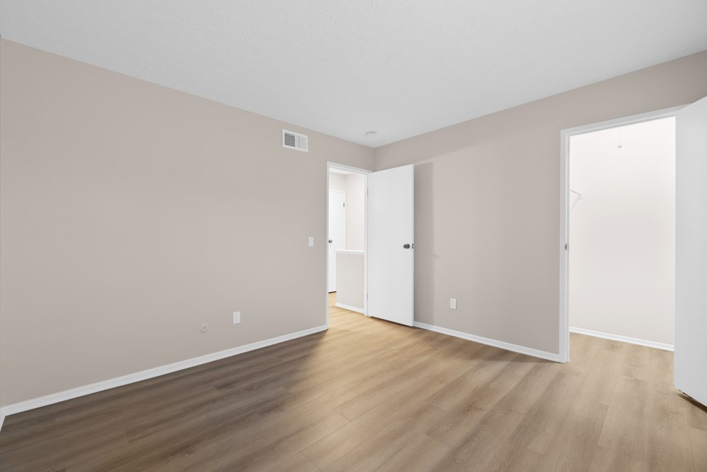 A room with wooden floors and white walls.