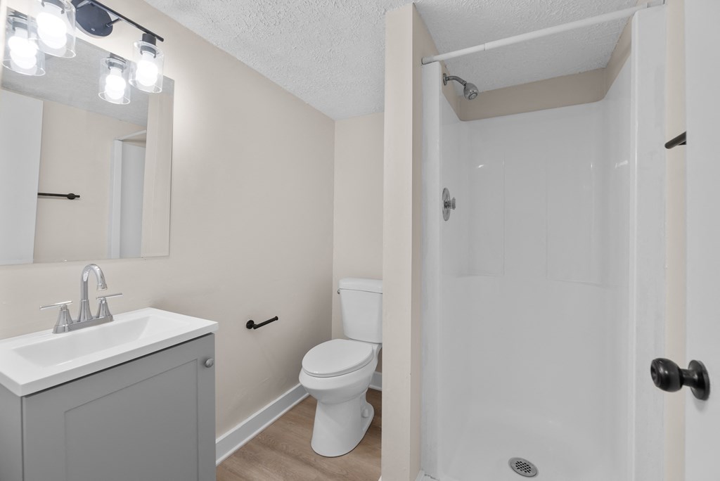 A white sink and toilet in a small bathroom.
