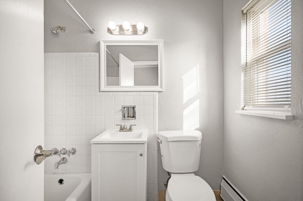 a bathroom with a toilet sink and a mirror