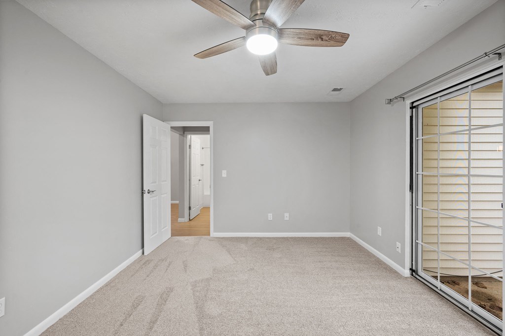 a bedroom with a ceiling fan and closet