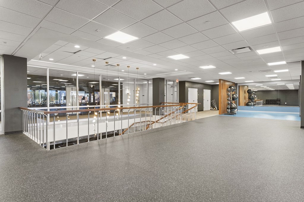 A spacious room with a long counter and a few chairs.