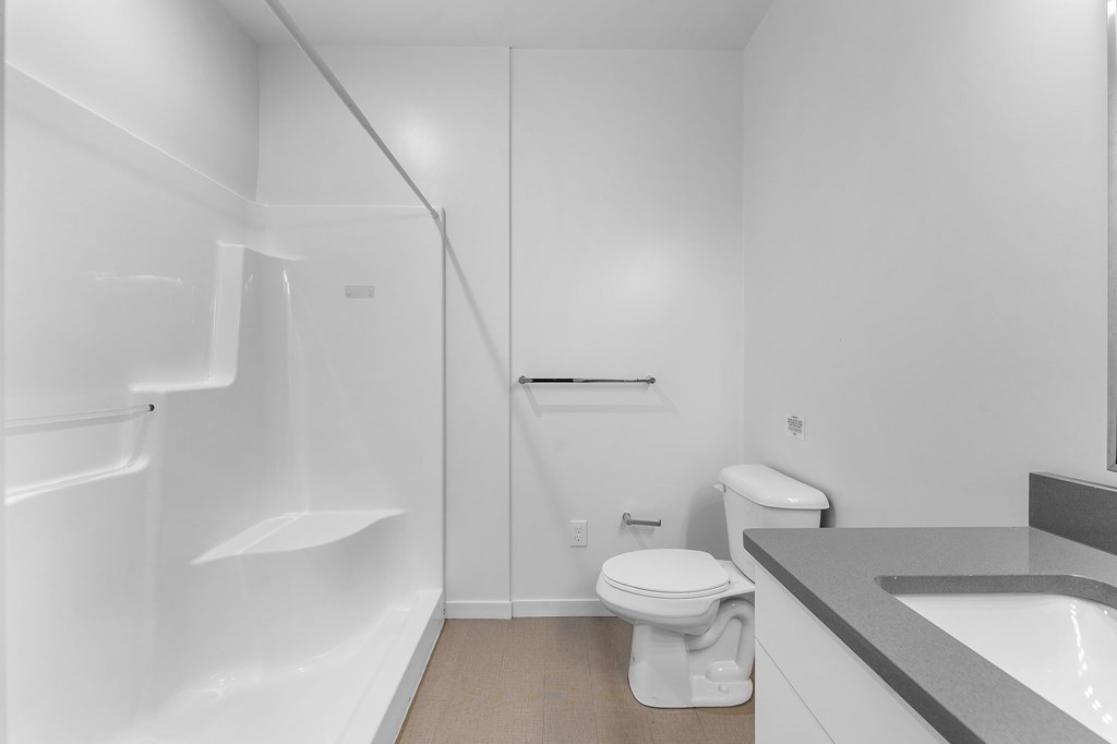 A white bathroom with a toilet, sink, and bathtub.