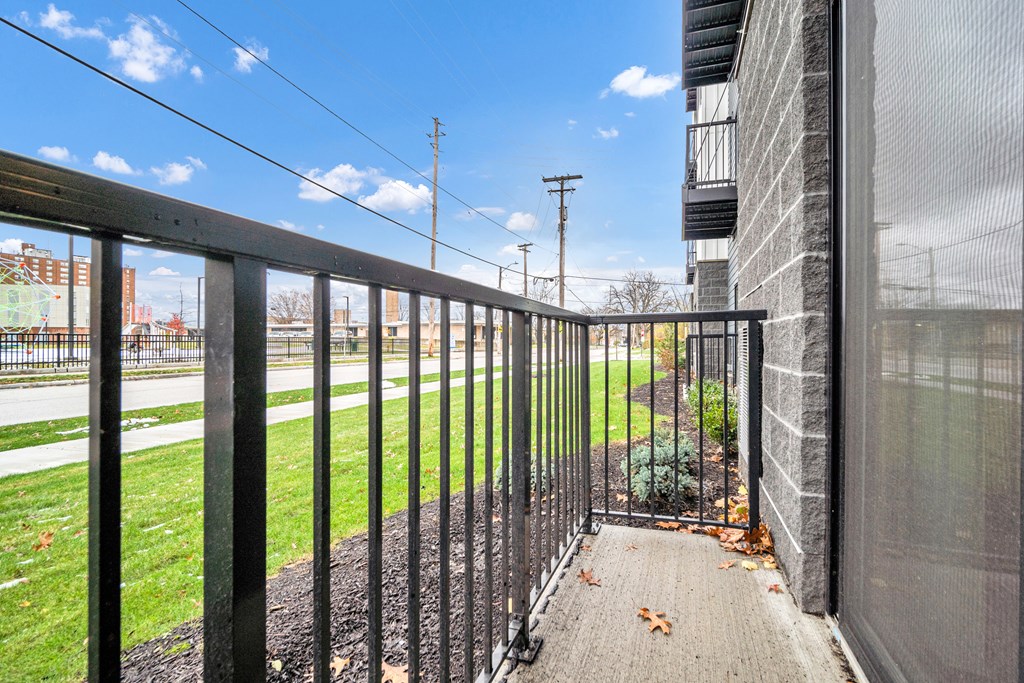 A black metal fence leads to a building entrance. at Park Lamont Townhomes Apartments, Cleveland, Ohio