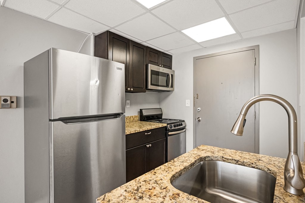 a kitchen with stainless steel appliances and granite counter tops