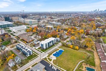 A view of a city from a high vantage point with buildings, trees, and a pool. at Park Lamont Townhomes Apartments, Cleveland, Ohio