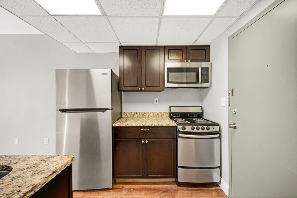 a kitchen with stainless steel appliances and wooden cabinets