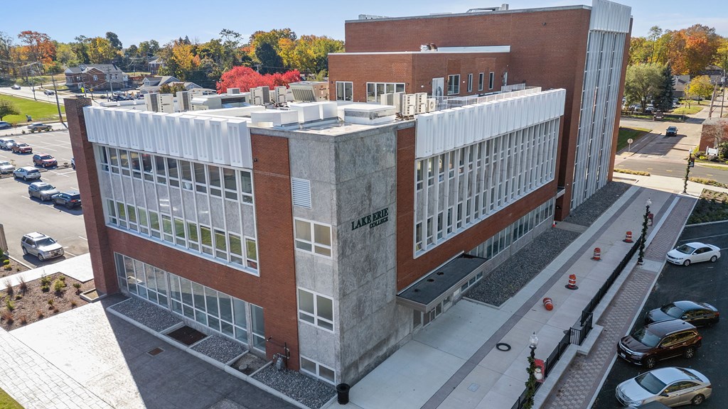 A large building with a parking lot in front of it.