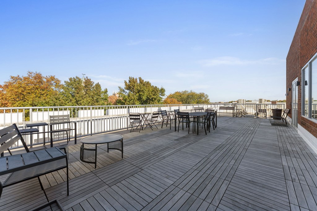 A wooden deck with chairs and a table.