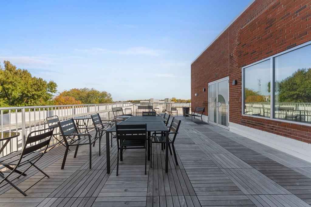 A wooden deck with a table and chairs.