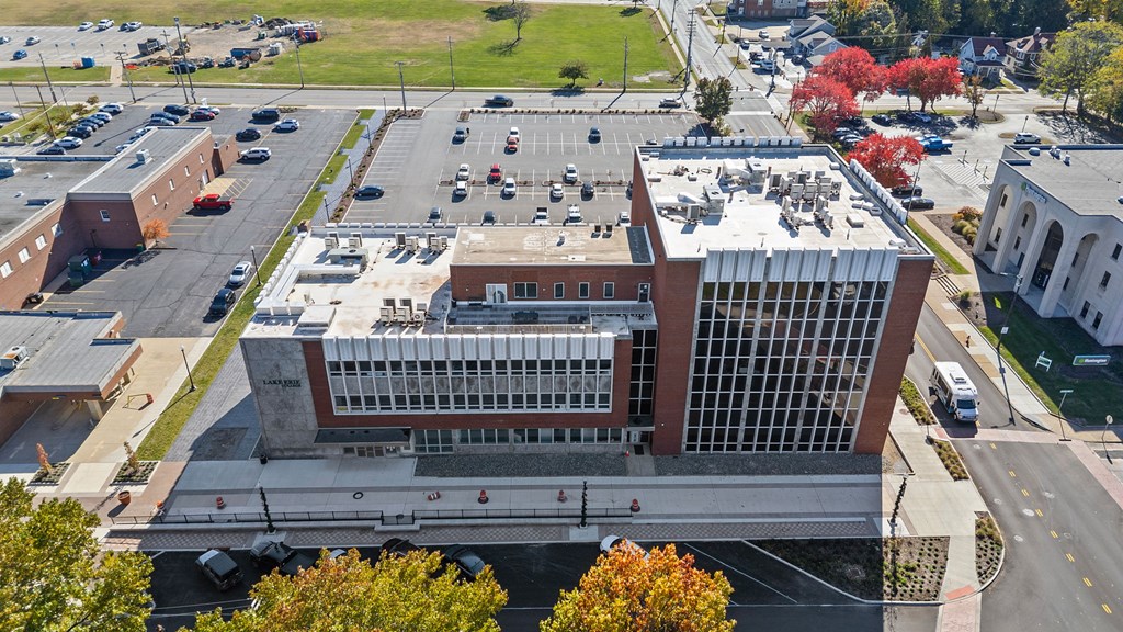 A large building with a parking lot in front of it.