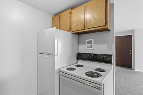 A white refrigerator and stove in a kitchen.