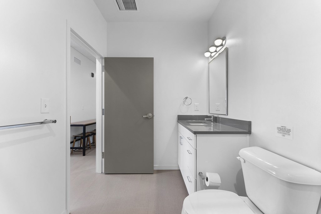 A white bathroom with a toilet, sink, and bathtub.