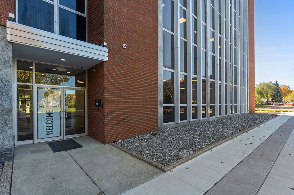 A building with a glass door and a sign that says
