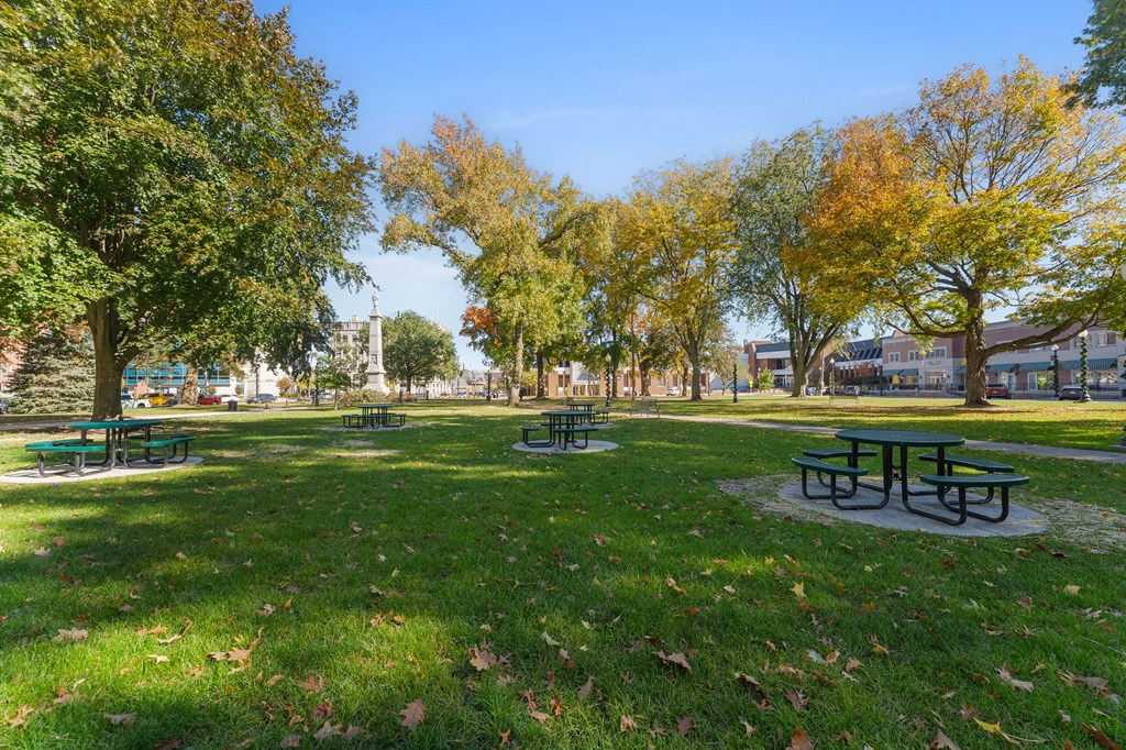 A park with green grass and trees.