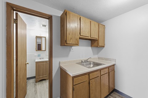 A kitchen with wooden cabinets and a white countertop.