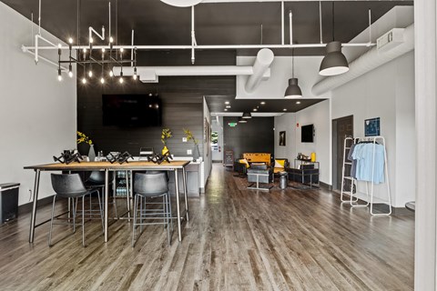 A modern dining area with a long table and chairs. at Vivo Toledo Apartments, Toledo, Ohio