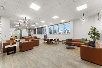 A modern office space with brown and orange furniture.