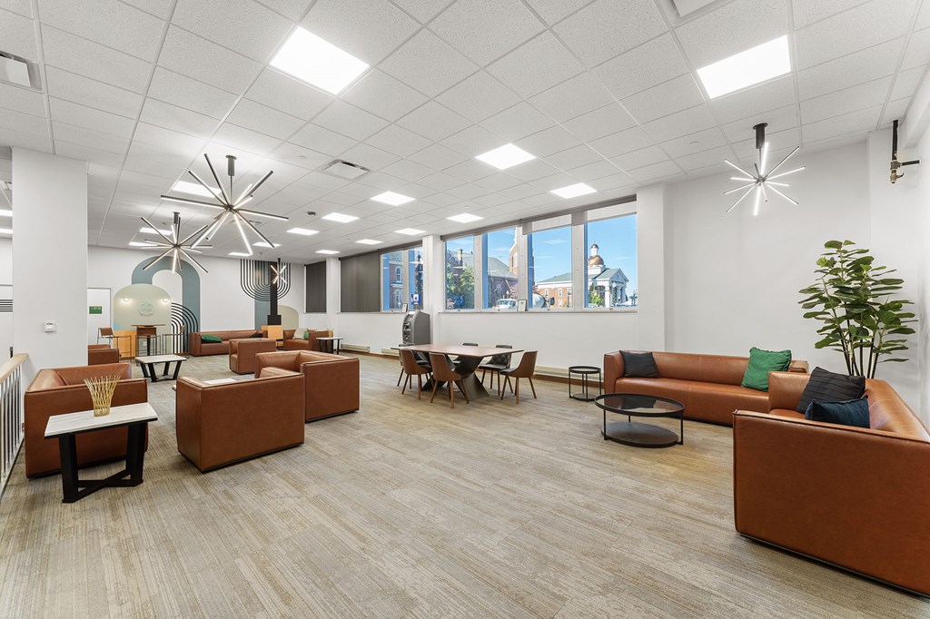A modern office space with brown and orange furniture.