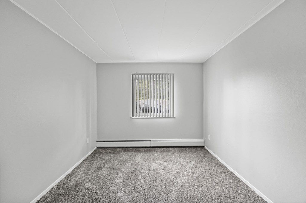 the living room of an empty house with a window