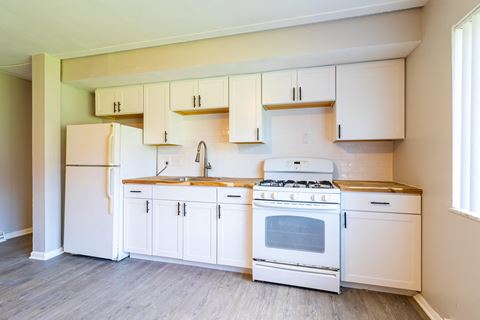 Upgraded kitchen with white appliances and cabinetry