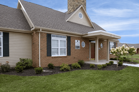 A house with a brown roof and a brick facade.