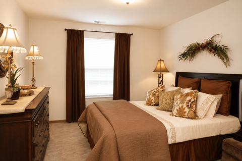 A bedroom with a large bed and a window with curtains.at Abbie Cove, Canal Winchester, OH, 43110