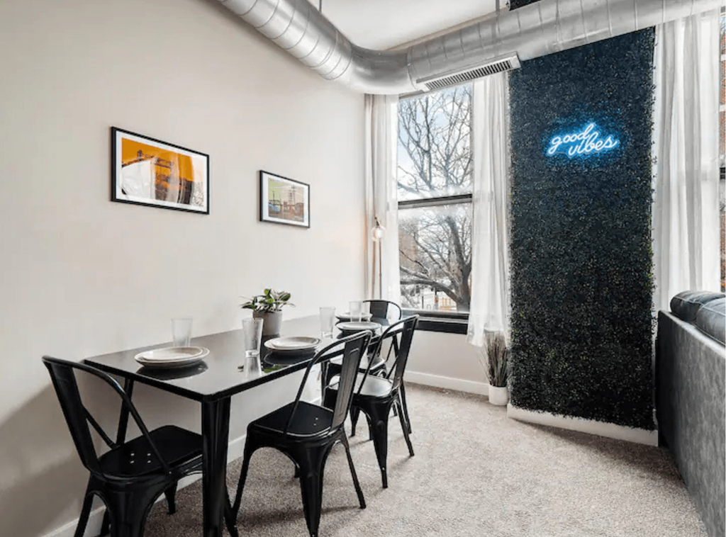 a dining room with a table and chairs and a window