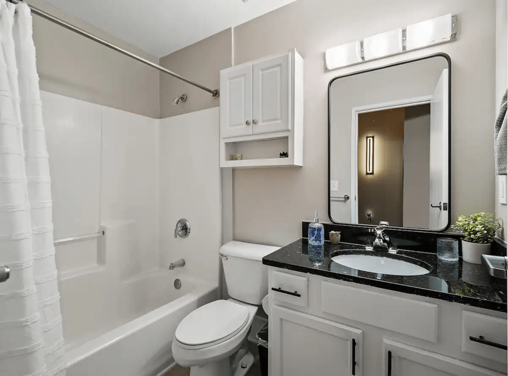 a bathroom with a sink toilet and a bath tub
