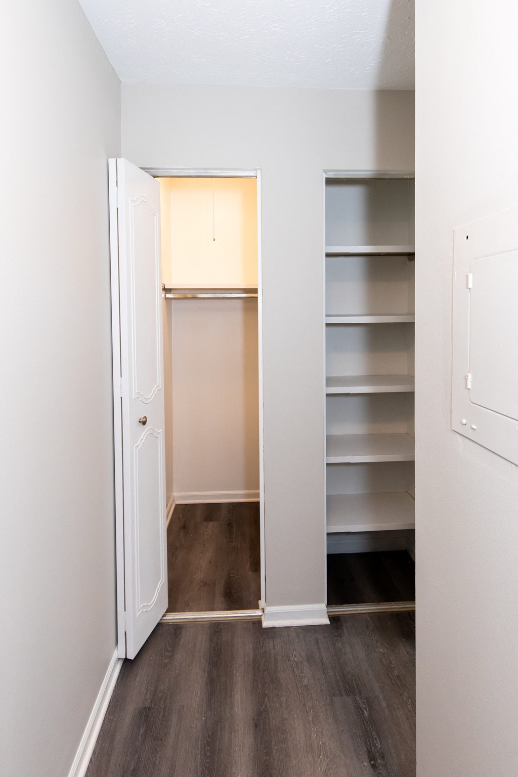 an empty closet in a room with a door open and shelves