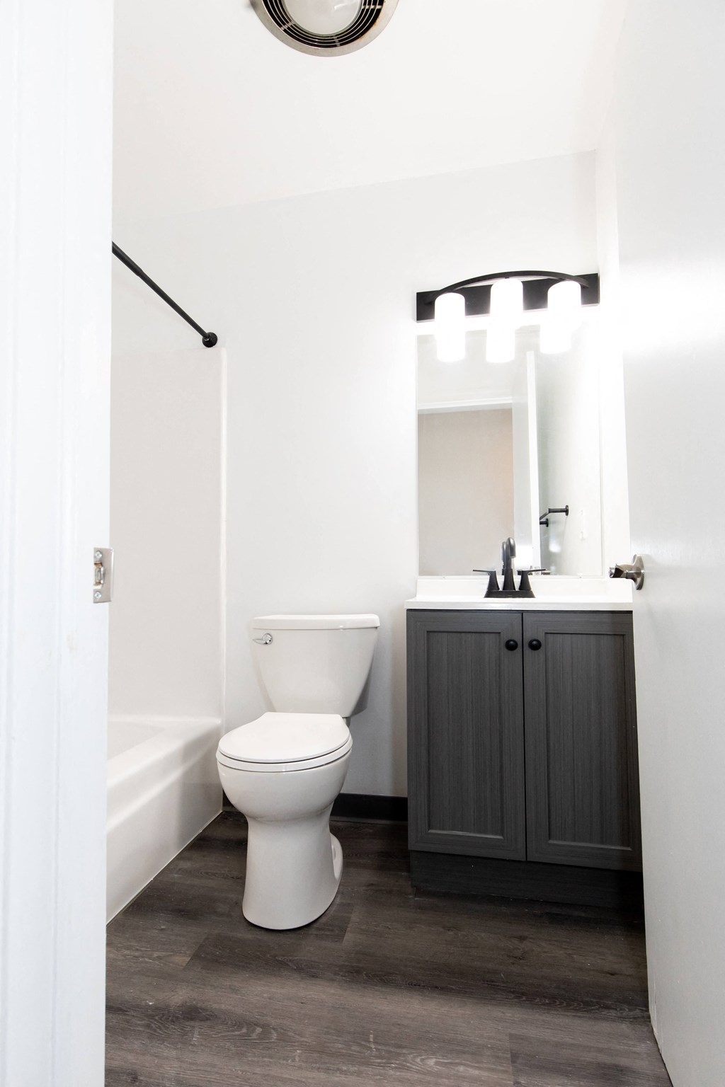 a white bathroom with a toilet and a sink