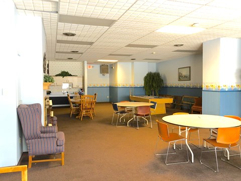 A room with a table and chairs.