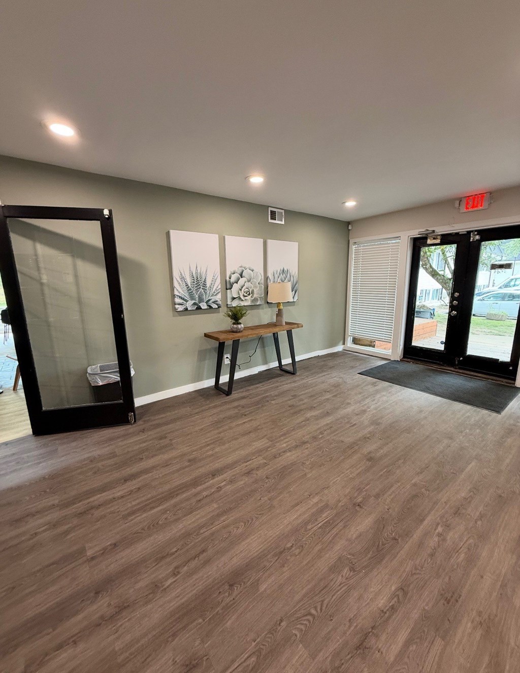 A room with a wooden floor and a glass door. at Commons At Waters Edge, Columbus Ohio