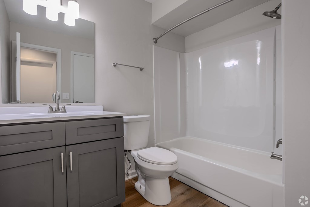 A white toilet sits next to a white sink in a bathroom. at Commons At Waters Edge, Columbus Ohio