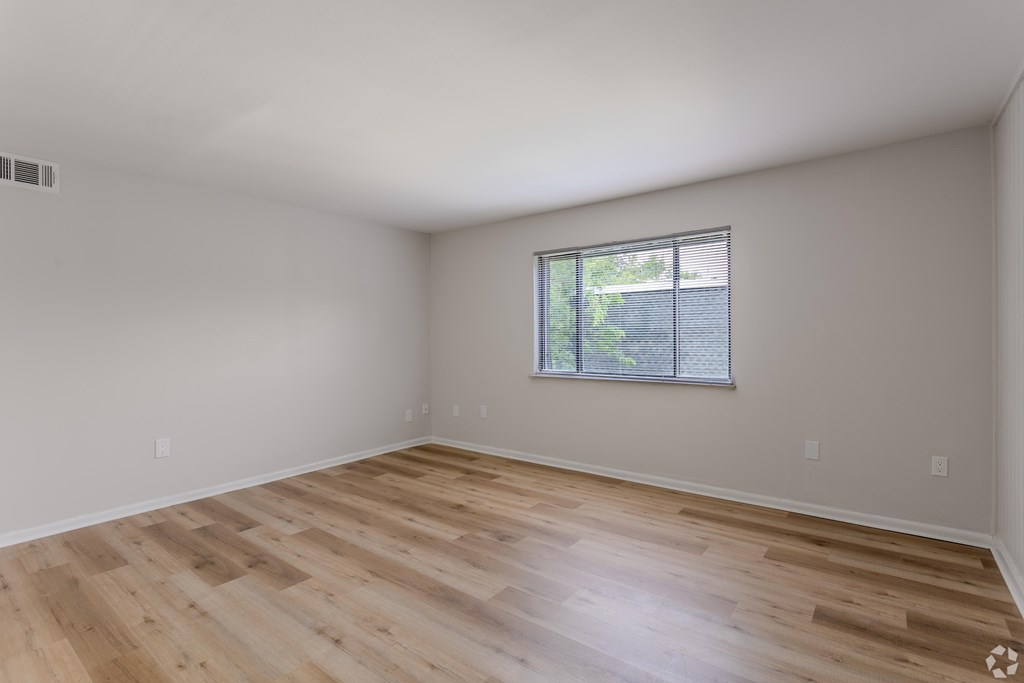 Empty room with wooden flooring and a window. at Commons At Waters Edge, Columbus Ohio