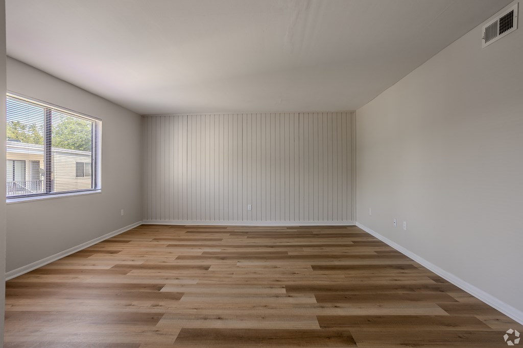 A room with wooden flooring and a window with blinds. at Commons At Waters Edge, Columbus Ohio
