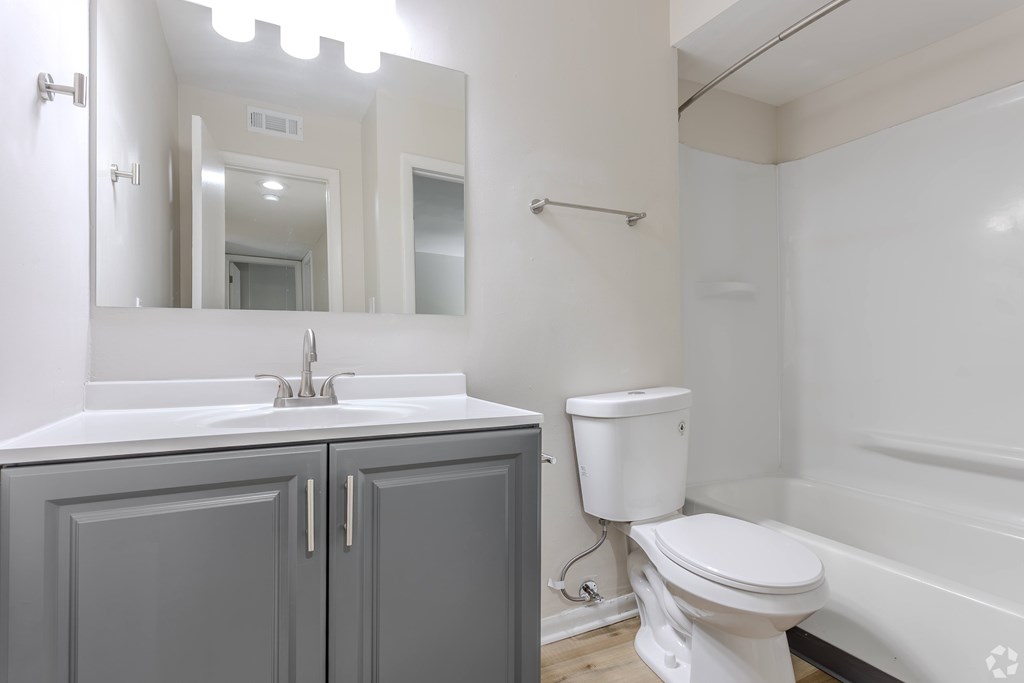 A white toilet sits next to a sink in a bathroom. at Commons At Waters Edge, Columbus Ohio