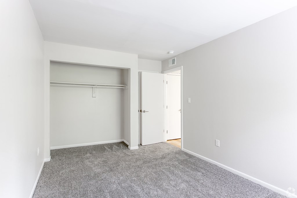 A room with a grey carpet and two white doors. at Commons At Waters Edge, Columbus Ohio
