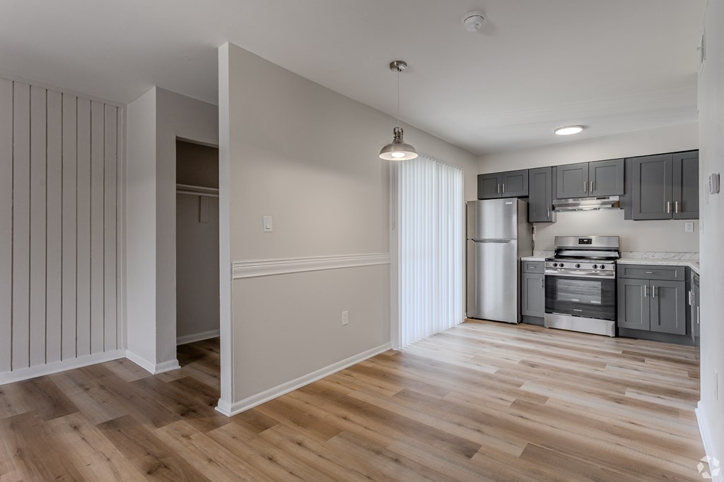 A kitchen with wooden floors and a white refrigerator. at Commons At Waters Edge, Columbus Ohio