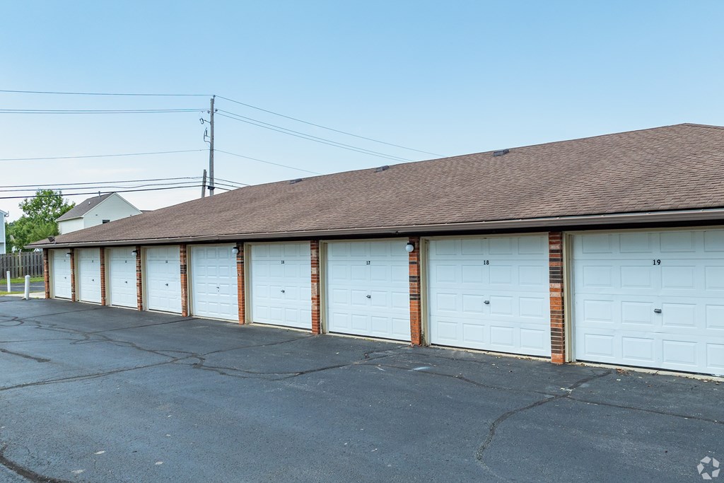 A row of white garage doors are closed.