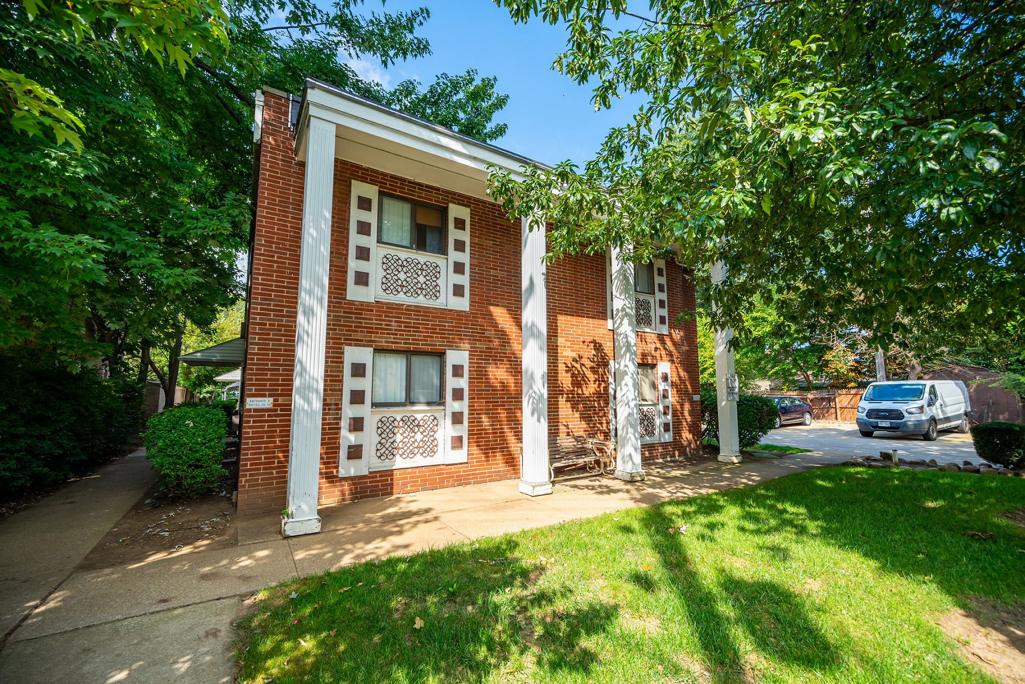 an old brick building with a car parked in front of it