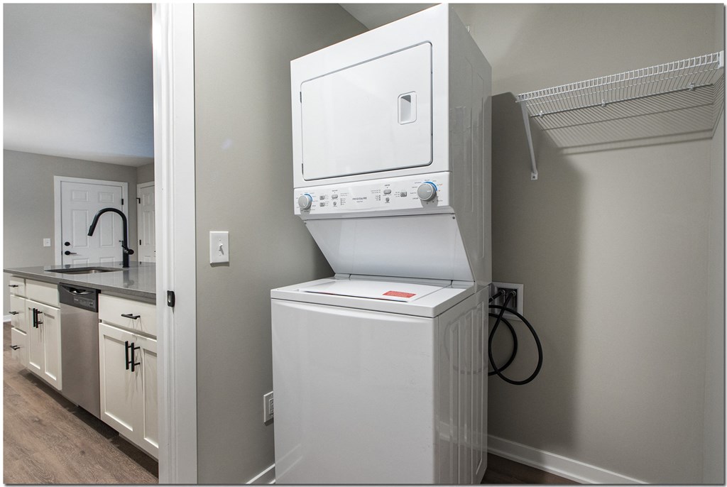 a laundry room with a washer and dryer and a sink