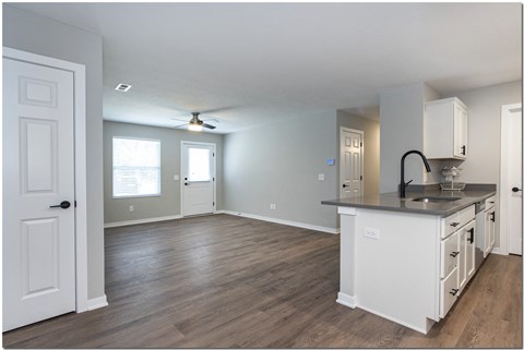 an empty kitchen and living room with an open floor plan