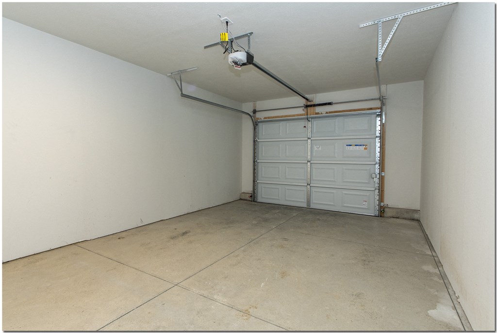 a garage with a door and a tile floor